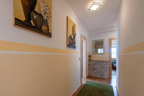 a hallway with two paintings on the wall at Ferienpension Steiner in Weerberg