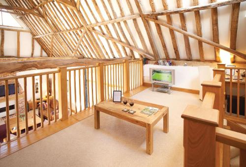 an overhead view of a living room with a table and a television at Thatch Barn in Lingwood