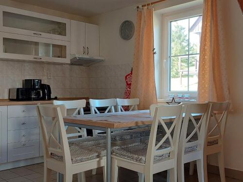a kitchen with a table and chairs and a window at Holiday Home Holiday Hill 39 by Interhome in Lauterwasser