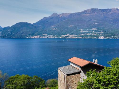 a house with a view of a lake and mountains at Apartment Dado by Interhome in Bellano