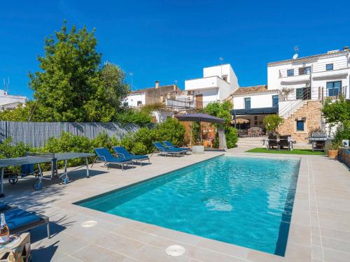 una piscina con sillas azules y un edificio en Holiday Home Can Rochet by Interhome, en Alaró