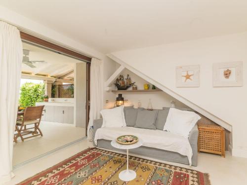 a living room with a couch and a table at Apartment La Nina by Interhome in Porto Rotondo