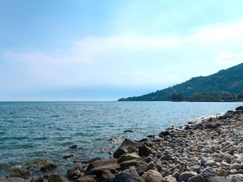 a rocky shore of a large body of water at Apartment Vista Mare by Interhome in Latte