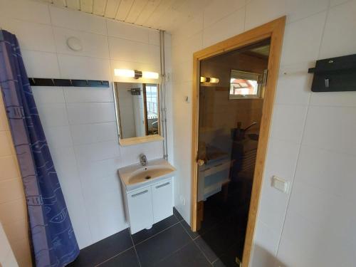 a bathroom with a sink and a mirror at Cottage with spa sauna boat as extra cost in Hult