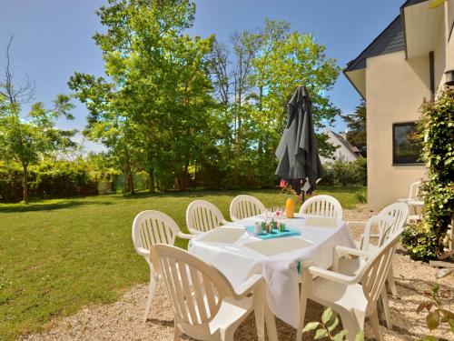 - une table et des chaises avec un parasol dans la cour dans l'établissement Holiday Home Charme de Kerfago by Interhome, à Saint-Gildas-de-Rhuys