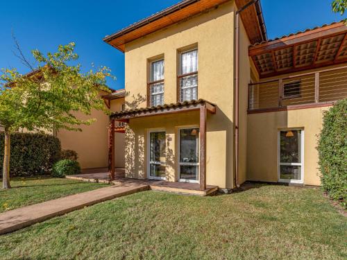 a house with a lawn in front of it at Apartment Residence Marina di Favone- T3- 4-6 pers-4 by Interhome in Conca