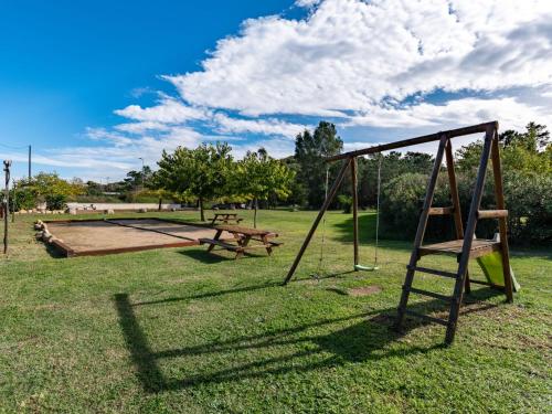 a park with two swings and a picnic table at Apartment Residence Marina di Favone- T3- 4-6 pers-4 by Interhome in Conca