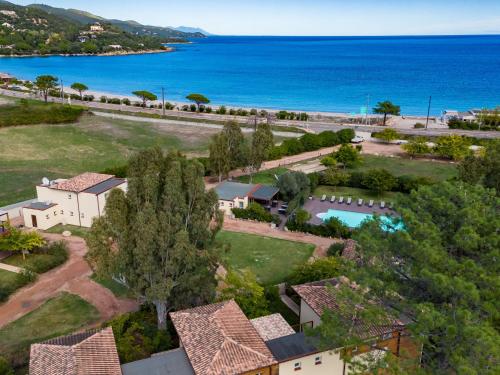 an aerial view of a house and the ocean at Apartment Residence Marina di Favone- T3- 4-6 pers-4 by Interhome in Conca