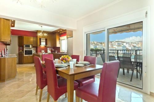 a dining room and kitchen with a table and chairs at Crystal Chateau: Μaisonette above the sea in Karpathos Town