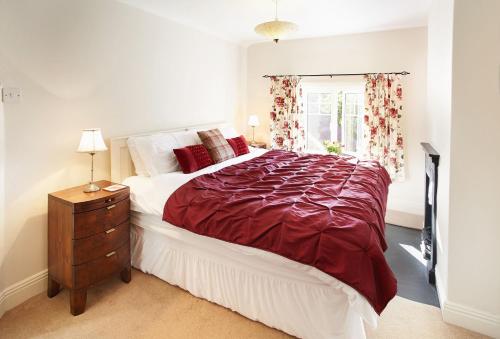 a bedroom with a large bed and a window at Heather Cottage in Gillamoor