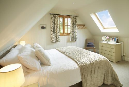 a bedroom with a white bed and a window at The Loft in South Stoke