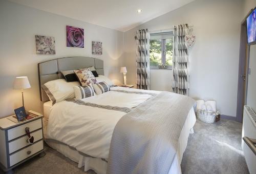 a bedroom with a large bed and a window at High Bridge Haven in Soutergate