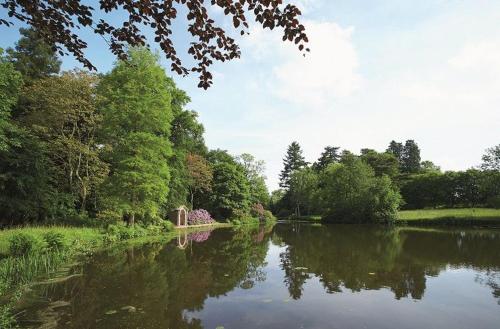a river with trees on the side of it at The Potting Shed in Weston under Lizard