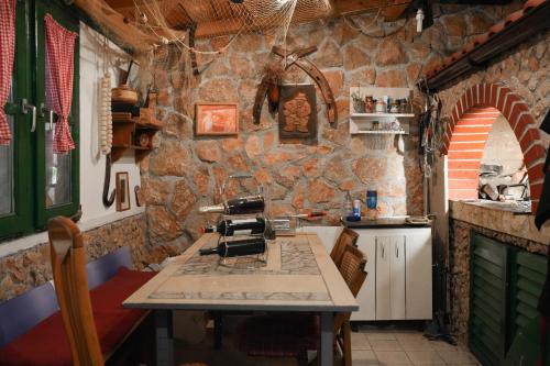 a kitchen with a stone wall and a counter top at Aurora apartments in Starigrad