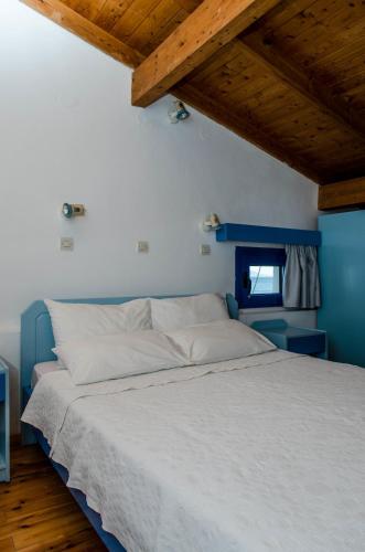 a large bed in a room with a wooden ceiling at Cleopatra Studios in Marathokampos