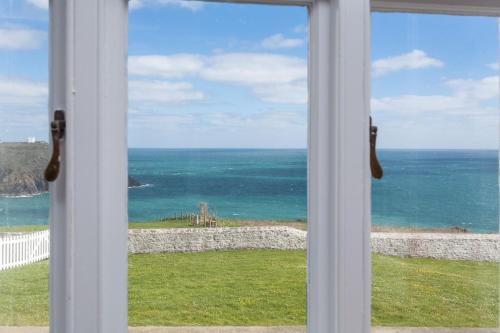 a view of the ocean from a window at Bishop Rock in Landewednack