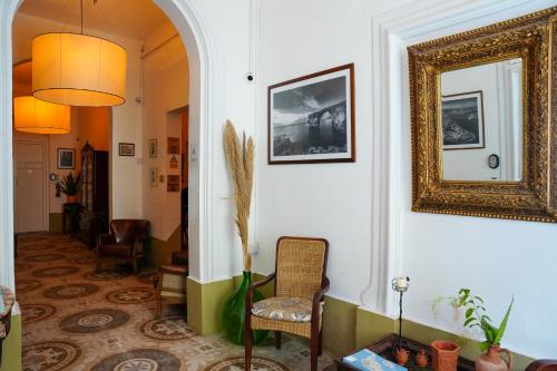 a hallway with a chair and a mirror on the wall at The Maltese Sun in Sliema