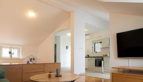 a living room with a flat screen tv on a wall at Mozart apartments in Baška Voda