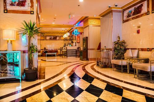 a lobby of a hotel with a checkerboard floor at Al Ritz Al Madinah in Al Madinah