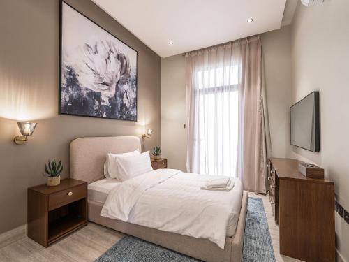 a hotel room with a bed and a television at Mabaat-Executive-Hittin 519 3BR-5-2 in Riyadh