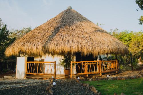 a small hut with a thatched roof at Villas Oasis, Troncones in Troncones