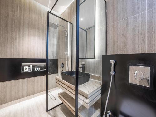 a bathroom with a sink and a shower at Mabaat-Executive-Hittin 519 3BR-5-2 in Riyadh