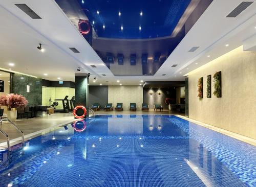 a large swimming pool in a hotel lobby at Marjan Plaza Hotel in Tbilisi City