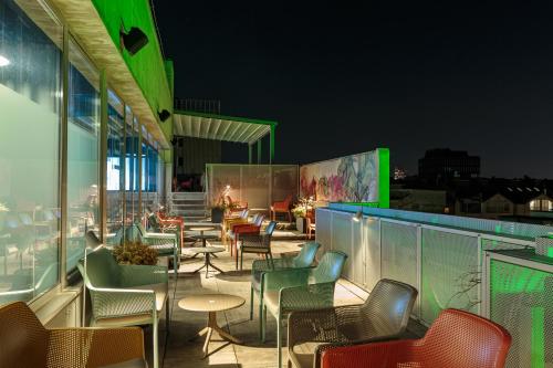 a patio with chairs and tables on a building at ibis Styles Ljubljana Centre in Ljubljana