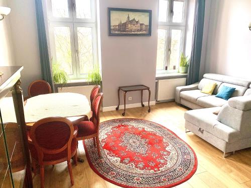 a living room with a table and a couch at 1 Bedroom Lux Apartment Center Vincent in Wrocław
