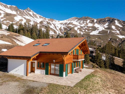 a house on a hill with mountains in the background at Chalet Martens by Interhome in Les Crosets