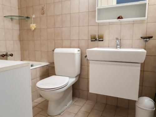 a bathroom with a toilet and a sink at Apartment Pérolles by Interhome in Fribourg