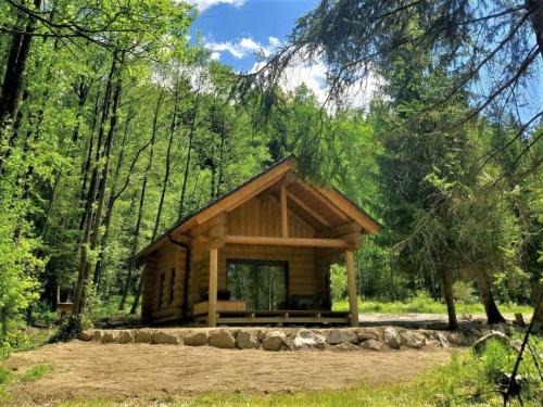 a log cabin in the middle of a forest at Chalet KuŘíp by Interhome in Benešov nad Černou