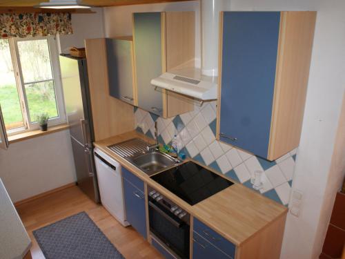 a small kitchen with a sink and a stove at Holiday Home Ferienhaus Reiter by Interhome in Rohrbach