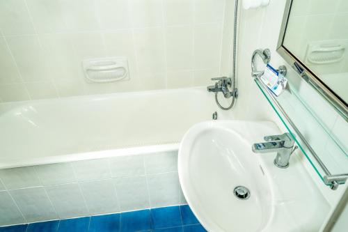 a bathroom with a sink and a bath tub at Aktea Beach Village in Ayia Napa