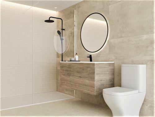 a bathroom with a sink and a toilet and a mirror at ATICO BOHIO premium in Benicàssim