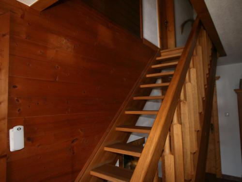 a wooden staircase in a room with wooden walls at Apartment Tom by Interhome in Schlitters