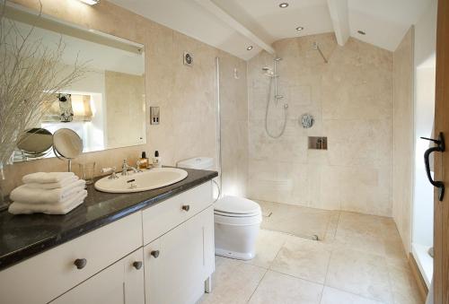 a bathroom with a sink and a shower and a toilet at Winsmore Cottage in Bakewell