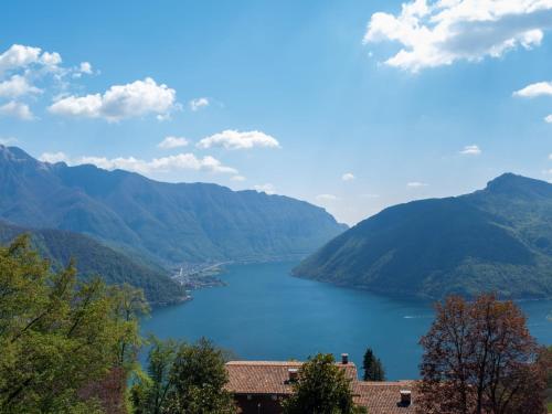 a view of a large lake in the mountains at Holiday Home Carina Lakeview by Interhome in Carona
