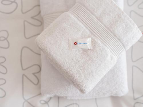 a white sweater with a tag on it at Holiday Home Carina Lakeview by Interhome in Carona