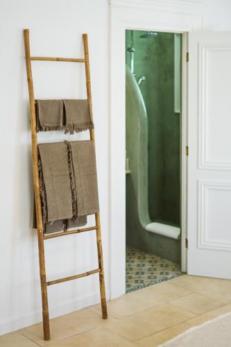 a ladder leaning against a wall next to a bathroom at 3-Room, 3-Bath Villa with Massive Pool, Central Location, Seconds from Cliff! in Imerovigli