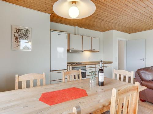 a kitchen and dining room with a table and a couch at Holiday Home Saga by Interhome in Bredebro