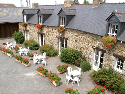 a group of white tables and chairs in front of a building at Apartment La Bisquine by Interhome in Saint-Jouan-des-Guérets