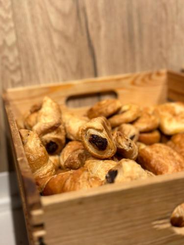a wooden box filled with different types of bread at Turia Valencia in Valencia