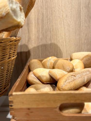 a wooden box filled with lots of bread at Turia Valencia in Valencia