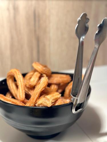 a bowl of food with pretzels and two utensils at Turia Valencia in Valencia