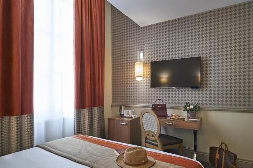 波爾多的住宿－Best Western Premier HBEO Bordeaux Centre，酒店客房配有一张床、一张书桌和一台电视。