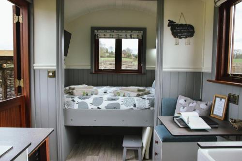 A bed or beds in a room at Spinney View Huts