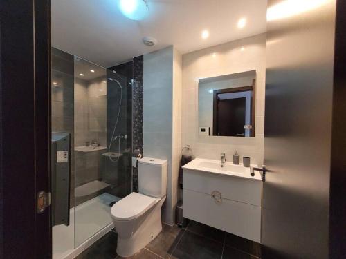 a bathroom with a toilet and a sink and a shower at La Mata Azul Beach 2 in Torrevieja