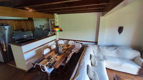 a living room with a table and a couch at Encantadora Casa adosada en Alp in Alp
