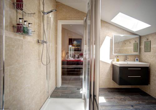 a bathroom with a shower and a sink at Beadnell Beach House in Beadnell